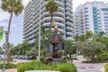 Beautiful view of tree-shaped statue with lock, set against backdrop of charming buildings on Collins Avenue in Miami Beach