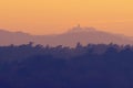 Beautiful view of treetops in layers and the Monrupino Church in distance Royalty Free Stock Photo