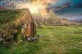 Beautiful view of a Troll House surrounded by trees and mountains under the sunset sky in Iceland