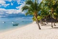 Beautiful view of tropical beach in Mauritius. Transparent ocean, beach, coconut palms and blue sky Royalty Free Stock Photo