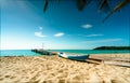 Beautiful view tropical paradise beach of resort. Coconut tree, wooden bridge, and kayak at resort on sunny day. Summer vacation Royalty Free Stock Photo