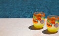 Beautiful view of two glasses of juice near the pool