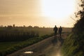 Beautiful view of two males walking on the background of a field at sunset in Plancenoit, Belgium