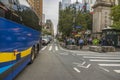 Beautiful view of vehicles and people on one of streets of New York city on bright summer day.