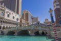 Beautiful view of the Venetian resort and casino featuring an artificial canal with gondolas gliding on blue water. Royalty Free Stock Photo