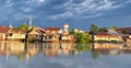 beautiful view of the village across the river. the reflection of the houses in the river water.