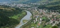 A beautiful view of the village of Mezhgorye, Carpathian region. A lot of residential buildings surrounded by high forest mountain Royalty Free Stock Photo