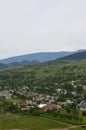 A beautiful view of the village of Mezhgorye, Carpathian region. A lot of residential buildings surrounded by high forest mountain Royalty Free Stock Photo