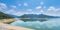 Beautiful view water in lake and high mountain with blue cloudy sky and many ship at port behind khun dan prakan chon dam in Royalty Free Stock Photo