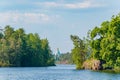 Beautiful view from the water to the island with the Orthodox Church on the horizon. St. Nicholas Skete of the Valaam Monastery. Royalty Free Stock Photo