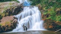 Beautiful view of the waterfall streaming down from the rocks into the river - great for wallpapers Royalty Free Stock Photo