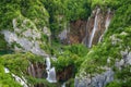 Beautiful view of waterfalls with turquoise water and wooden pathway through over water. Plitvice Lakes National Park, Croatia. Fa Royalty Free Stock Photo