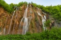 Beautiful view of waterfalls with turquoise water and wooden pathway through over water. Plitvice Lakes National Park, Croatia. Fa Royalty Free Stock Photo