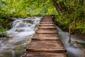 Beautiful view of waterfalls with turquoise water and wooden pathway through over water. Plitvice Lakes National Park, Croatia. Fa Royalty Free Stock Photo