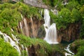 Beautiful view of waterfalls with turquoise water and wooden pathway through over water. Plitvice Lakes National Park, Croatia. Fa Royalty Free Stock Photo