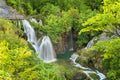 Beautiful view of waterfalls with turquoise water and wooden pathway through over water. Plitvice Lakes National Park, Croatia. Fa Royalty Free Stock Photo