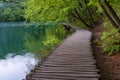 Beautiful view of waterfalls with turquoise water and wooden pathway through over water. Plitvice Lakes National Park, Croatia. Fa Royalty Free Stock Photo