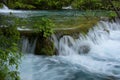 Beautiful view of waterfalls with turquoise water and wooden pathway through over water. Plitvice Lakes National Park, Croatia. Fa Royalty Free Stock Photo