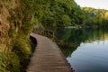 Beautiful view of waterfalls with turquoise water and wooden pathway through over water. Plitvice Lakes National Park, Croatia. Fa Royalty Free Stock Photo