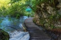 Beautiful view of waterfalls with turquoise water and wooden pathway through over water. Plitvice Lakes National Park, Croatia. Fa Royalty Free Stock Photo
