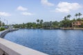 Beautiful view of waterfront promenade alongside luxurious villas in Miami Beach featuring yacht parking area and palm trees Royalty Free Stock Photo