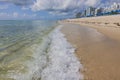 Beautiful view of wave rolling on to white sandy beach of Atlantic Ocean and blue sky with white clouds. Miami Beach. Royalty Free Stock Photo