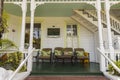 Beautiful view of white guest house. Brown armchairs and coach on the front porch. Tourism concept. Key Wes. Florida. USA. Royalty Free Stock Photo