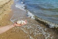 Beautiful view of white stones lying on palm in hand of a man on seashore. Royalty Free Stock Photo