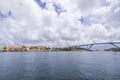 Beautiful view of Willemstad with the high Connexion Bridge over Saint Anna Bay against a blue sky with fluffy white clouds. Royalty Free Stock Photo