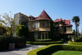 Beautiful view of the Winchester Mystery house with a trimmed garden in the yard in San Jose