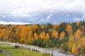 Beautiful view from the window of city apartment on the road and fall forest. Autumn city landscape Royalty Free Stock Photo