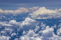 Beautiful view from window of plane flying over clouds. White clouds moving above the ground.