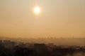 Beautiful view of winter morning fog and sun filling on landscape of houses and buildings in Belgrade. Scenery during sunrise. Royalty Free Stock Photo