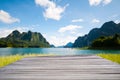 Beautiful view of wooden bridge in front of the meadow, turquoise lake, mountain and sky in summer with reflections in a lake at Royalty Free Stock Photo