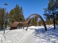 Beautiful view of a wooden installation and a path in a snowy city park. Noyabrsk, Russia