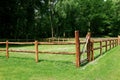 Beautiful view of wooden paddock, forest and green grass Royalty Free Stock Photo