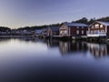 Beautiful view of  wooden red houses near a lake with reflection in the water in Bonhamn, Sweden Royalty Free Stock Photo