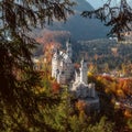 Beautiful view of world-famous Neuschwanstein Castle with Alpine mountains on Background, under sunlit. Wonderful sunny landscape Royalty Free Stock Photo