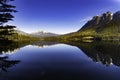 Mountains in morning light reflected in calm lake