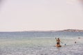 Beautiful view of young man floating on surfboard. Calm waters of Mediterranean.