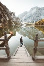 Young man watching sunrise at Lago di Braies, South Tyrol, Italy