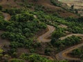 Beautiful view of zigzag roads with green forest trees around
