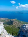 Beautiful view of Zlatni rat beach on the island of Brac in Croatia during hot summer day and green vegatation agianst blue sky Royalty Free Stock Photo