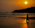 Beautiful views of the beach evening. A woman is walking in it.