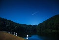 Beautiful views of nature at night with shooting star in northern Thailand dam.