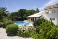 Beautiful villa with a healthy garden and a pool Royalty Free Stock Photo