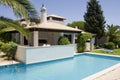 Beautiful villa with a healthy garden and a pool Royalty Free Stock Photo