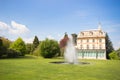 Beautiful village house, villa with garden fountain and blue sky background Royalty Free Stock Photo