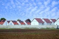 beautiful village landscape, row cottages, houses behind fence, arable land, fields, blue skies, agricultural concept, growing Royalty Free Stock Photo