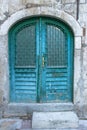 Beautiful vintage blue painted door. Blue grunge wooden door in brick wall. Old rustic wooden doors in Montenegro Royalty Free Stock Photo